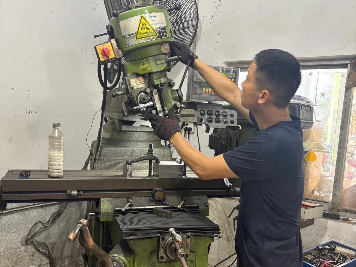 Technician machining a metal dice production mold