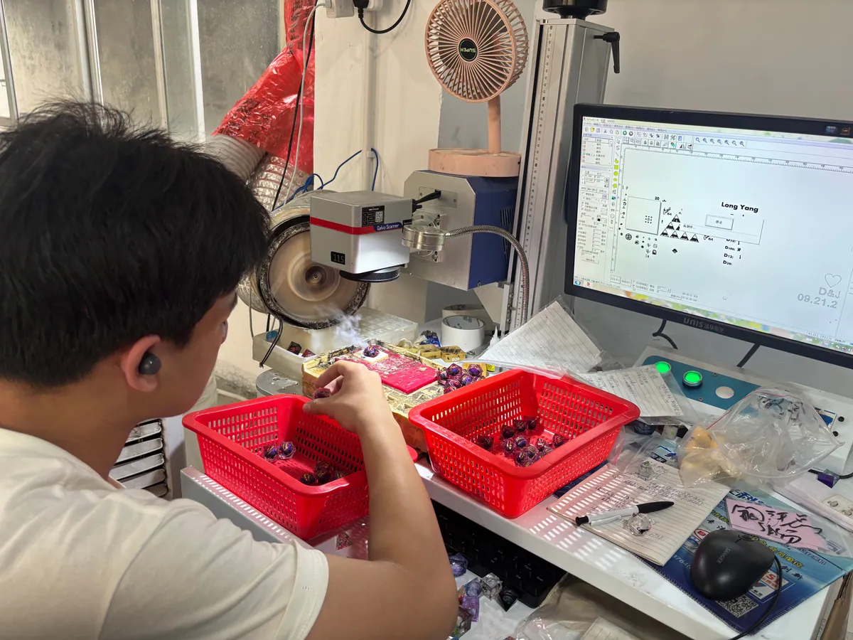 Laser engraving workstation marking numbers on resin dice